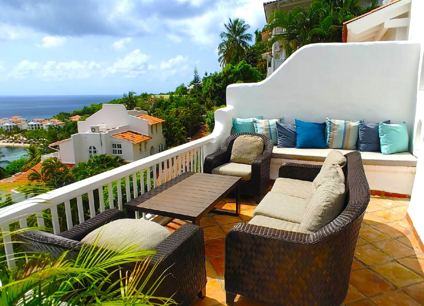 St. Lucia Real Estate Windjammer Landing 2 Bed Villa outdoor deck featuring a table and wicker chairs